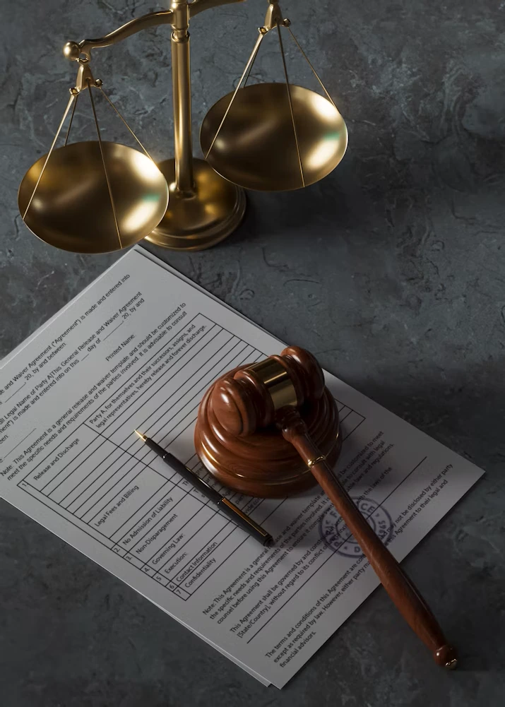 Brass scales of justice, a wooden gavel, and legal documents